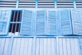 Facade of and old building, wide windows with open shutters Royalty Free Stock Photo