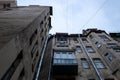 Facade of an old building with windows view from below in cloudy weather