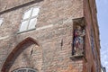 Facade of an old bulding with a statue of the Virgin Mary with J