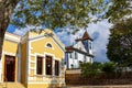 Facade of old colonial style house and baroque church Royalty Free Stock Photo