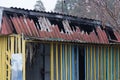 Facade of an old colored fire-burned barn