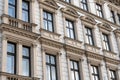 Facade of an old European building with windows, columns and decorative stucco in a classical style Royalty Free Stock Photo