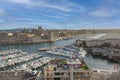 Facade of old historic castle and the promenade with sailing boats in the harbor