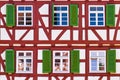 Facade of old historic timber framing building with red timber beams