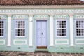 Facade of an old house located in front of Francisco Cunha Square featuring green and white painting and light blue windows