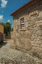 Old house with stone wall and small window in an alley Royalty Free Stock Photo