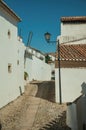 Facade of old houses with whitewashed wall in alley on slope Royalty Free Stock Photo