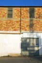 A facade of an old industrial building with an old yellow