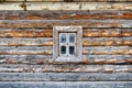 Facade of an old log house with a small window Royalty Free Stock Photo