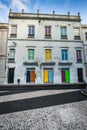 Facade of the old Portuguese houses with colorful doors and wind Royalty Free Stock Photo