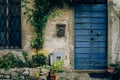Facade of an old house with shabby walls and a blue painted wooden door Royalty Free Stock Photo