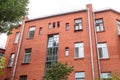 The facade of the old red brick building that was built 100 years ago against the backdrop of the White Sky. Ancient Royalty Free Stock Photo