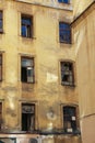 facade of an old resettled abandoned apartment building with broken windows Royalty Free Stock Photo
