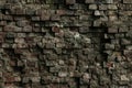 Facade of an old ruined building. Texture of a shattered grunge cement wall. The gray dirty dilapidated brick wall background Royalty Free Stock Photo