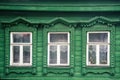 facade of the old Russian village wooden house with carved ornaments elements