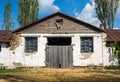 Facade of an old stone barn with old wooden gate in the countryside Royalty Free Stock Photo