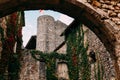 Facade of old stone buildings in Perouges, red windows, flowers, ivy, France Royalty Free Stock Photo