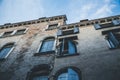 Facade of an old Venetian brick building with an open window and a clear blue sky, Venice, Italy Royalty Free Stock Photo