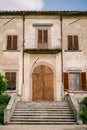 Facade Of An Old Villa In Italy, In Florence. Stone Stairs, Wooden Door, Windows With Wooden Shutters.
