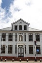 Facade of an old white wooden house with a Virgin Mary statue, in the historic center of Paramaribo, Suriname Royalty Free Stock Photo