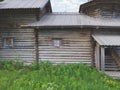 Facade of old wooden house. small windows. entrance with porch. traditional architecture Royalty Free Stock Photo