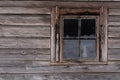 The facade of an old wooden log building with a small window Royalty Free Stock Photo