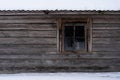 The facade of an old wooden log building with a small window Royalty Free Stock Photo