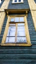 Facade of old wooden residential building with yellow window. Green housing concept from natural eco wood. Rural scene. Rental Royalty Free Stock Photo