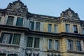 Facade of an old and worn building, classic architecture and windows Royalty Free Stock Photo