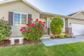 Facade of a one storey single family home with plants and flowers in the yard Royalty Free Stock Photo