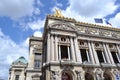 Facade of the Opera de Paris with golden statues and flags on the roof. Royalty Free Stock Photo