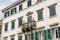 The facade of an ordinary old building with windows and a balcony in Montenegro. Royalty Free Stock Photo