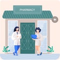 Facade pharmacy store with signboard, awning and symbol in shopwindow. Pharmacists women at entrance