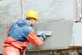 Facade work. builder plastering outside wall with putty knife float Royalty Free Stock Photo