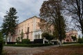 Facade of polish noble Ignacy Witoslawski palace on late summer cloudy day, fallen leaves in the park, Cherniatyn, Ukraine