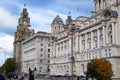 Facade of Port of Liverpool Building or Dock Office with the tower of the Royal Liver Building at the background in Pier Head,