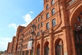 Lodz - Poland. 17 August 2019: Facade of red brick factory building. Old factory in Lodz Royalty Free Stock Photo