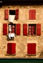 Facade with red wood shutters Royalty Free Stock Photo
