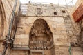 The facade of a residential building decorated with decorative stucco in the Arabian style and suras from the Koran, carved in