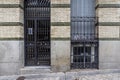 Facade of a residential building with granite blocks on the ashlars and black metal portal and bars on the windows