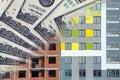 The facade of a residential high-rise house on a background of money . Royalty Free Stock Photo