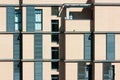 Residential high-rise modern building facade, windows with blue wooden shutters. Royalty Free Stock Photo