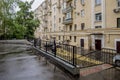 Facade of a residential multi-storey building and a courtyard in the center of Moscow on a spring day