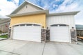 Facade of residential two car garage with gable roof and white panelled doors Royalty Free Stock Photo