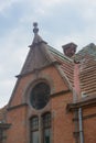 Facade of roof old house in Zelenogradsk. Round window in attic. German architecture last century Royalty Free Stock Photo