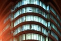 The facade of a round glass building with large panoramic windows and balconies at night, the windows glow in dark. Dnipro city, Royalty Free Stock Photo