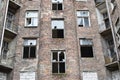 Old red brick house with broken windows, former Jewish ghetto in Warsaw Royalty Free Stock Photo