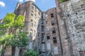 Facade of ruined old vintage red brick house with broken windows location: Kamienico, part of former Jewish ghetto, Walicow Royalty Free Stock Photo