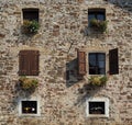 facade of a rural house with flowers in every window