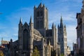 Facade of Saint Nicholas` Church Sint-Niklaaskerk with the clock tower of Belfry of Ghent Het Belfort at the background, in Royalty Free Stock Photo